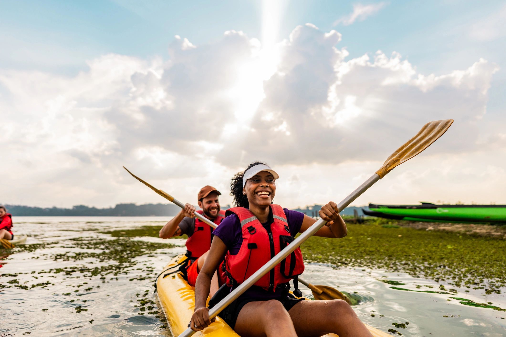 Two people kayaking together on calm water